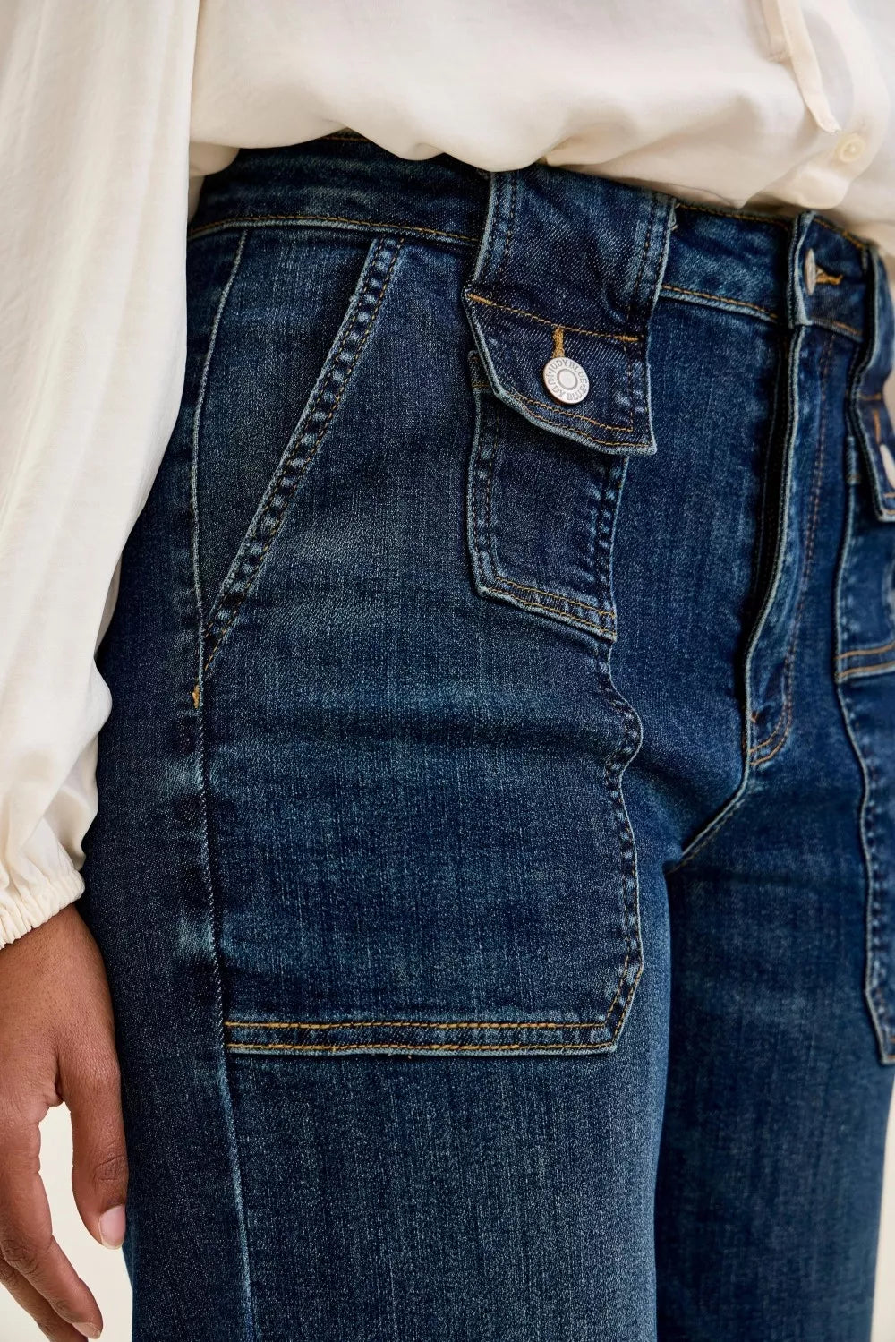 Women’s dark blue denim utility jeans with large front patch pocket and topstitching