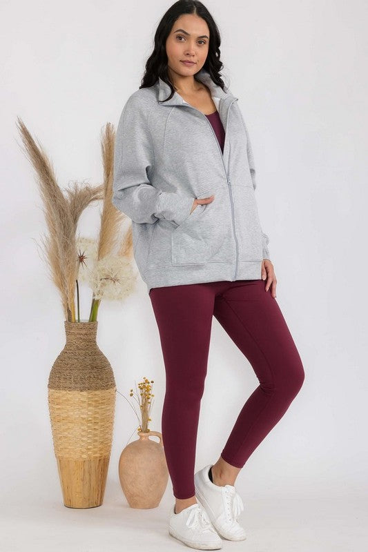 Light grey funnel-neck zip jacket with patch pockets and raglan sleeves, oversized