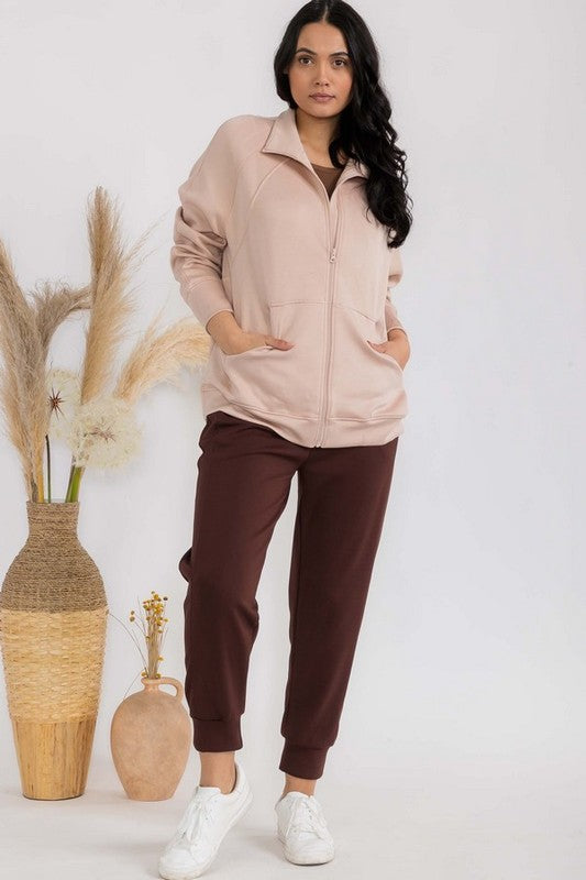 Blush apricot funnel-neck zip jacket with front zip, patch pockets and raglan sleeves