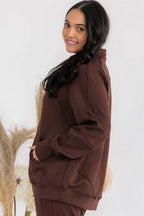Maroon oversized zip-up jacket with funnel neck and raglan sleeves, side view