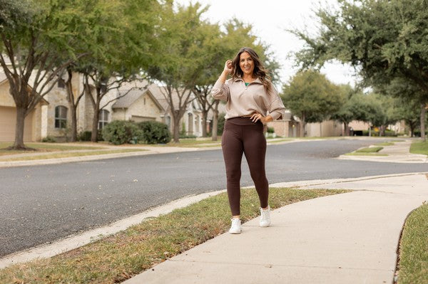Brown crossover yoga leggings with fitted leg and side pockets