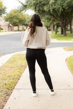 Black high-waist full-length leggings viewed from behind, straight leg
