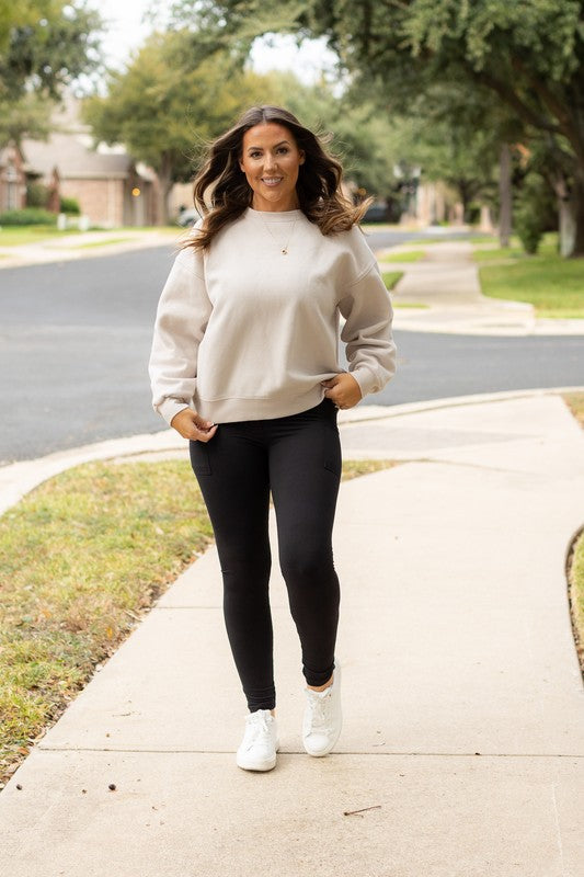 Black high-waisted full-length leggings on a model, full-body front view.