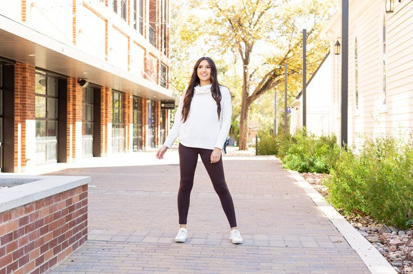 Brown full-length crossover leggings with pockets and tapered legs