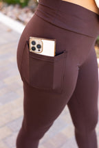Brown leggings with front pocket opening and phone-sized slot detail