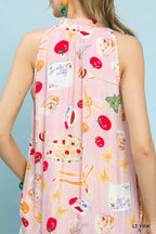 Light pink halter back with colorful abstract fruit, star, and beverage print