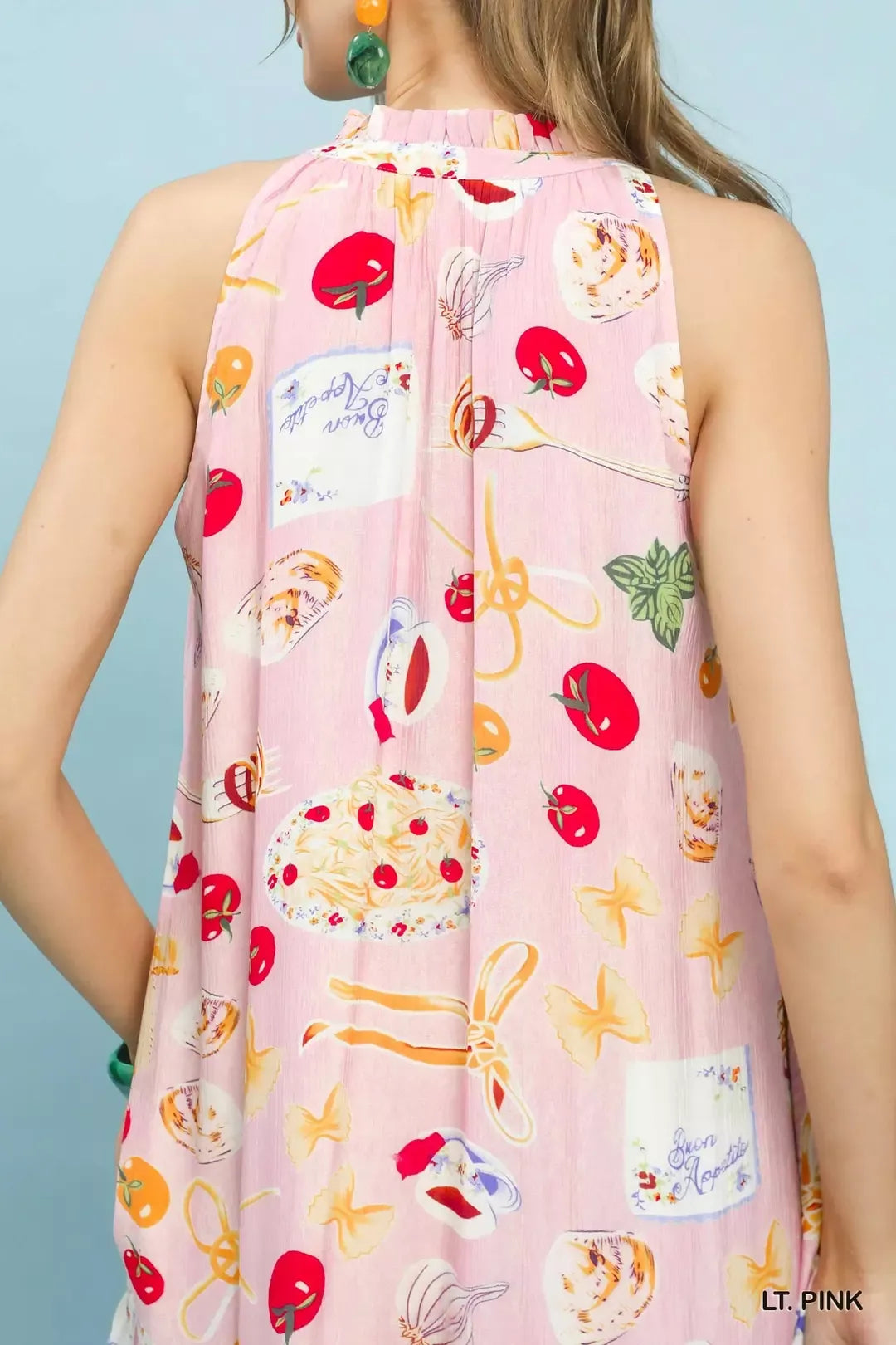 Light pink halter back with colorful abstract fruit, star, and beverage print