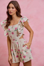 Ivory floral print denim romper with ruffled shoulders, square neckline, and belted waist