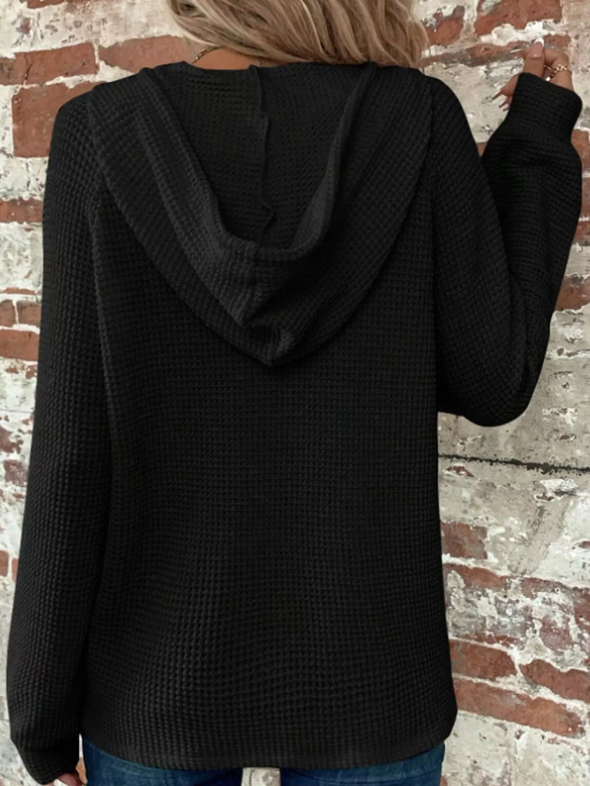 Black waffle-knit button hoodie with hood and long sleeves, back view