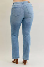 Light blue mid-rise bootcut jeans with back patch pockets and clean stitched waistband