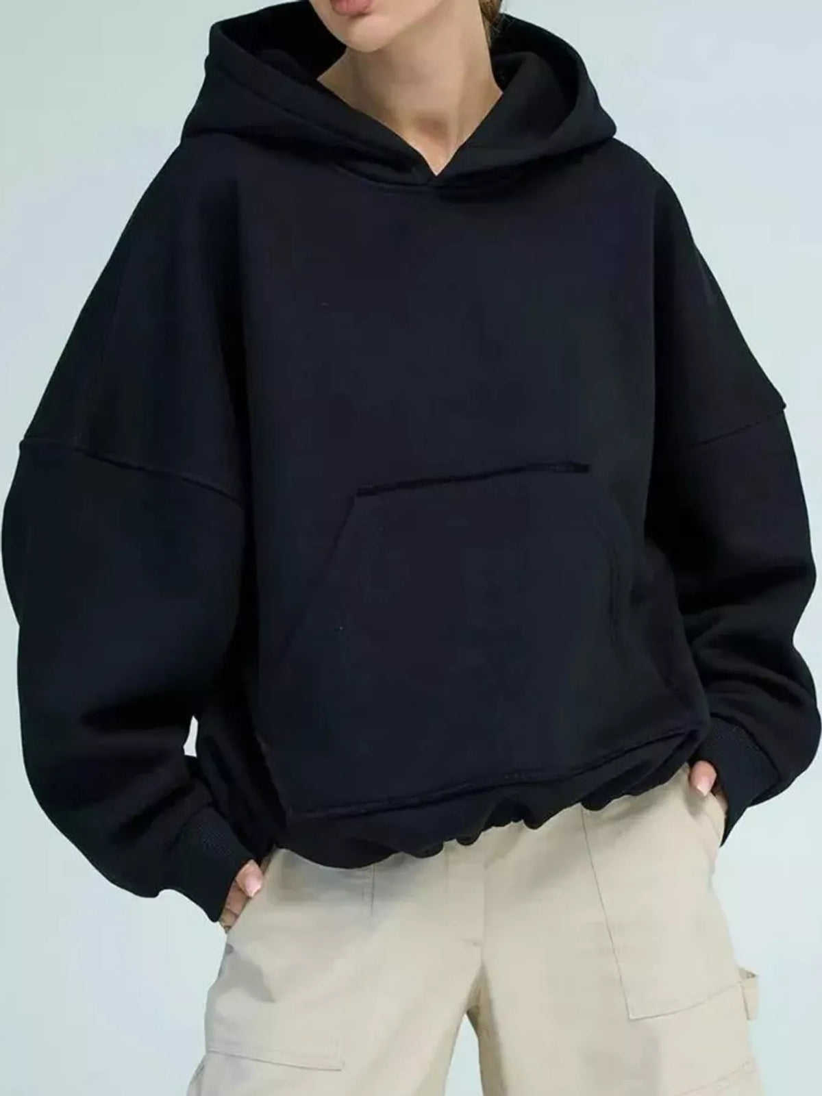 Black oversized kangaroo pocket hoodie with drawstring hood and front pouch pocket