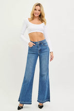 Women's high-rise wide-leg jeans in medium blue denim, released hem