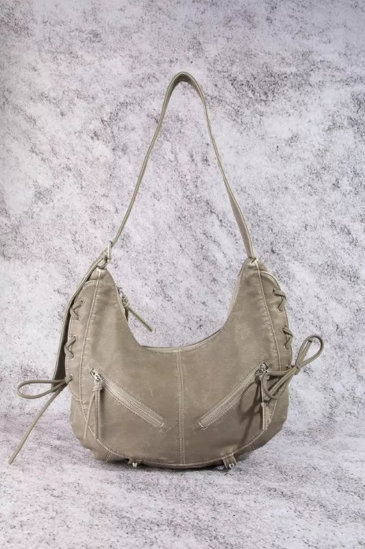 Light beige crescent shoulder bag with double straps, zip pockets, and drawstring ties