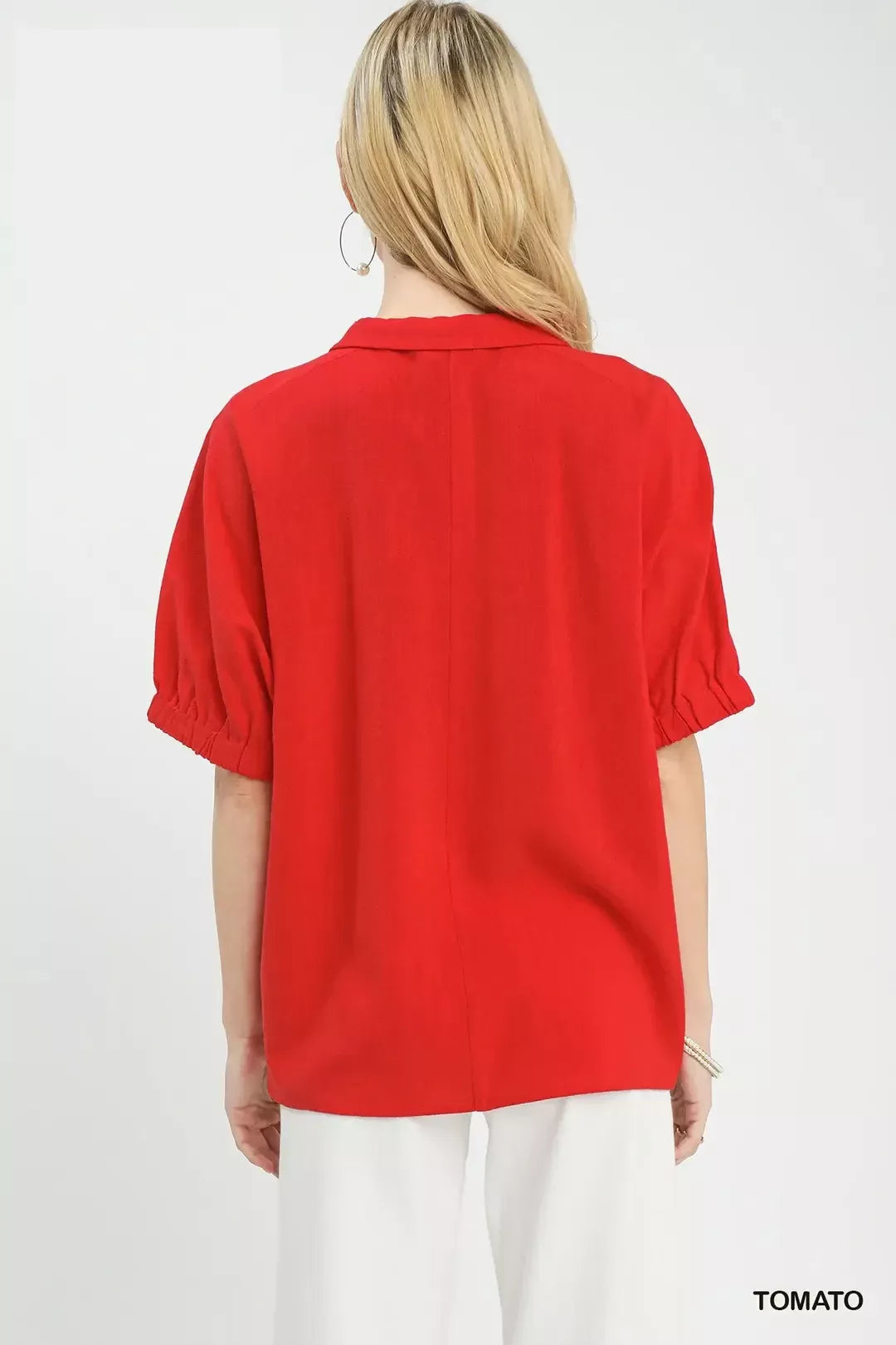 Red blouse back view with short sleeves and a folded collar.