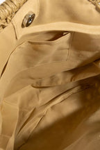 Bag lining with tan fabric, visible seams and snap button hardware