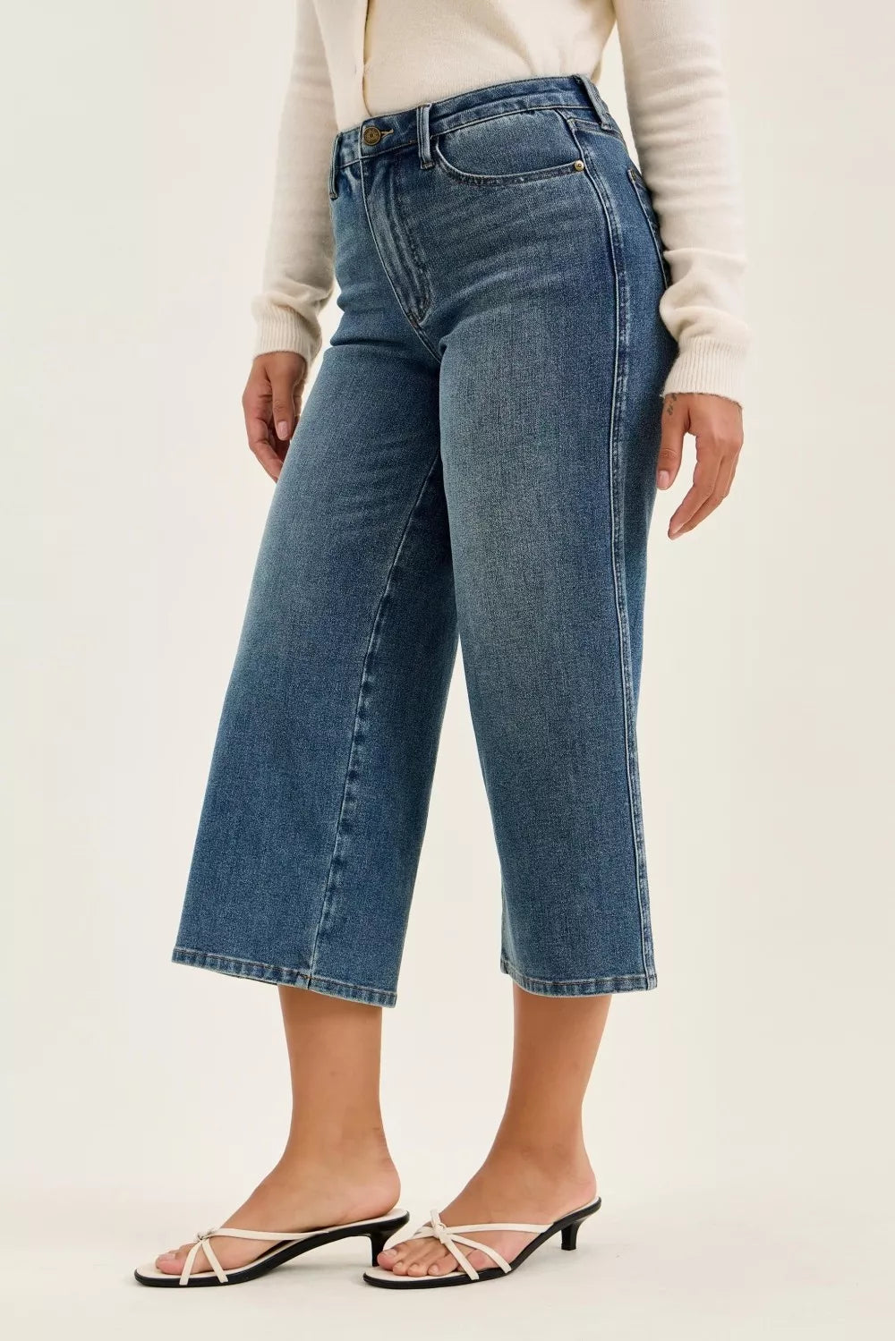 Mid-wash wide-crop jeans with relaxed fit, front pockets, and belt loops