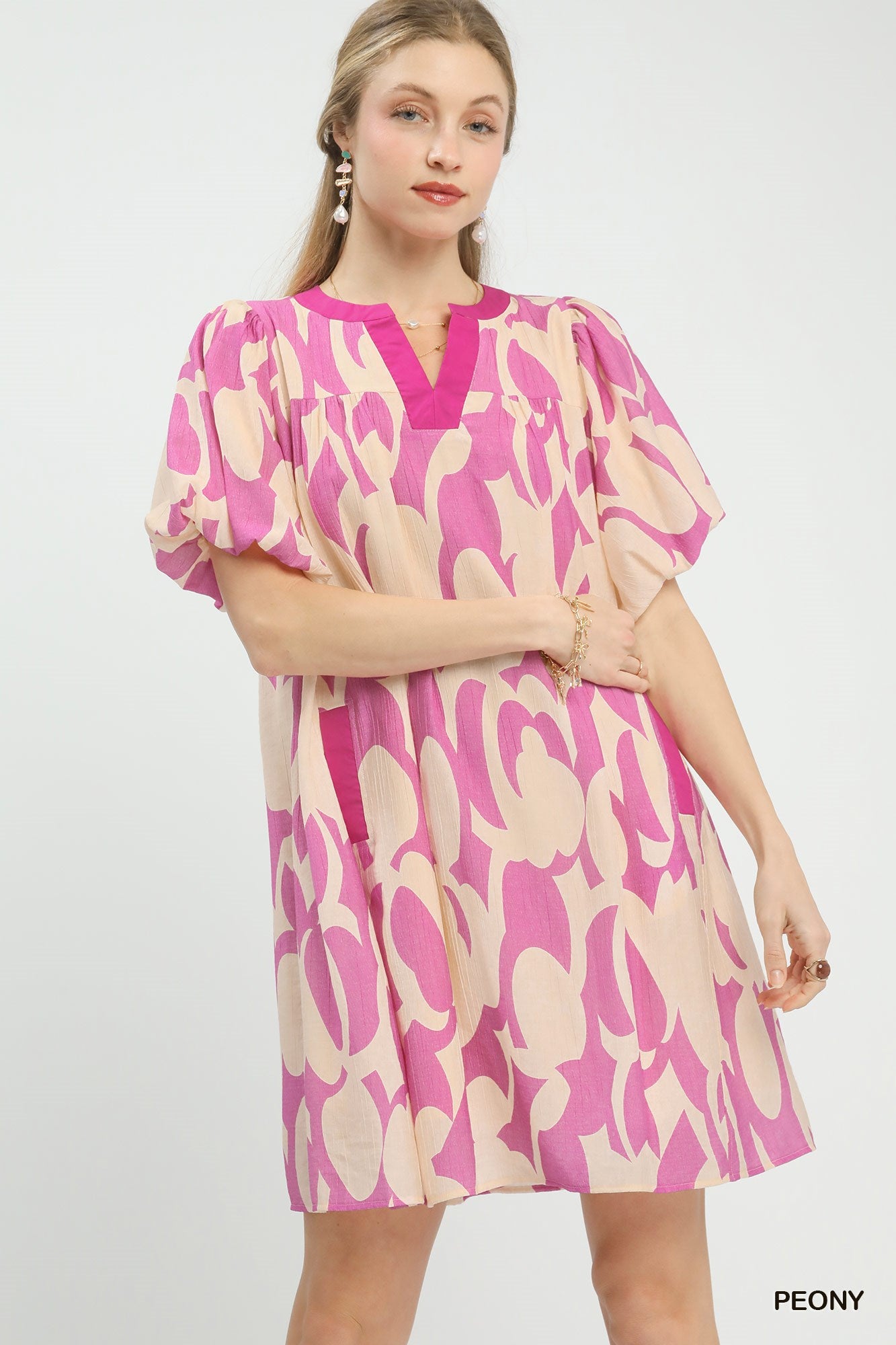 Pink and cream patterned mini dress with V-neck and puff sleeves