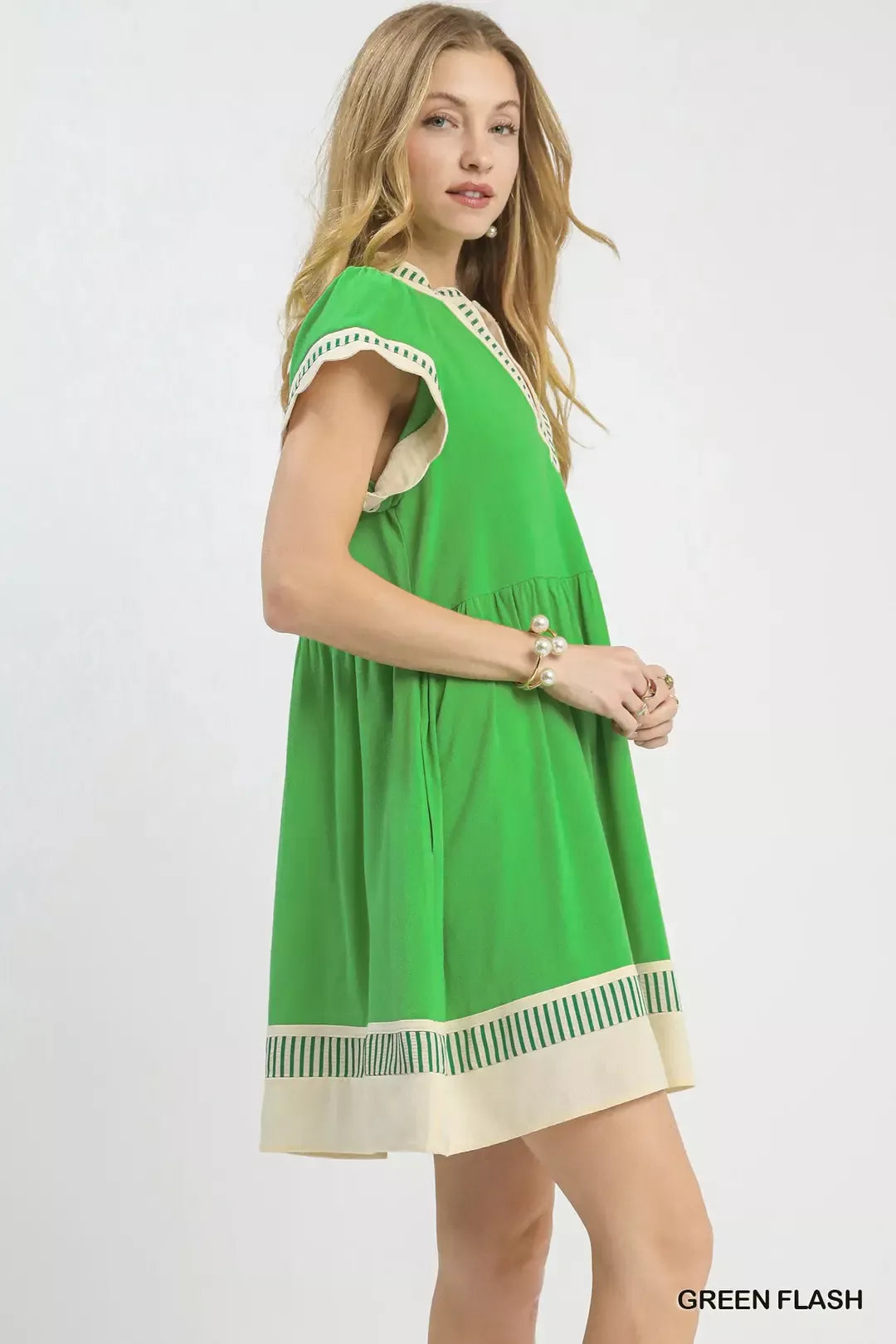 Green flutter sleeve dress with V-neck and cream striped border at hem