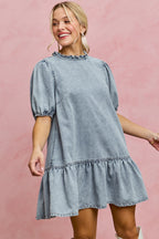 Light-wash denim mini dress with ruffled neckline, puff sleeves, gathered skirt hem