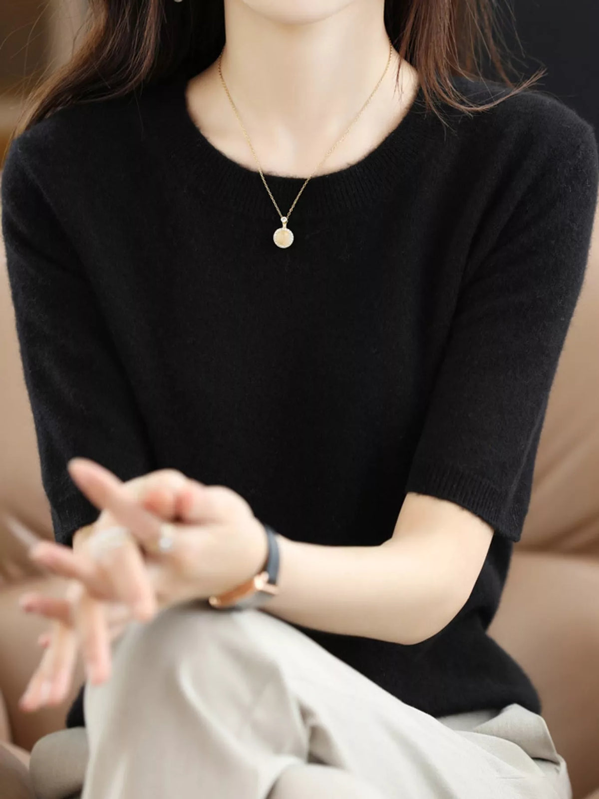 Black round-neck short-sleeve knit sweater with ribbed cuffs and neckline