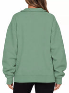 Light green oversized zip-neck sweatshirt back view with ribbed hem and cuffs