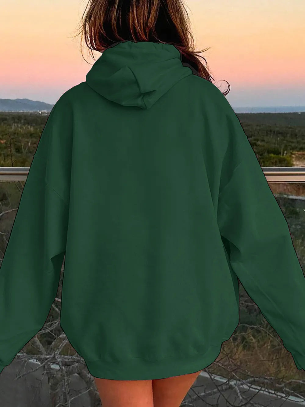 Deep green hoodie from the back with drawstring hood and relaxed dropped shoulders.