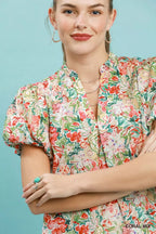 Floral puff-sleeve blouse in coral mix with V-neck and button placket detail