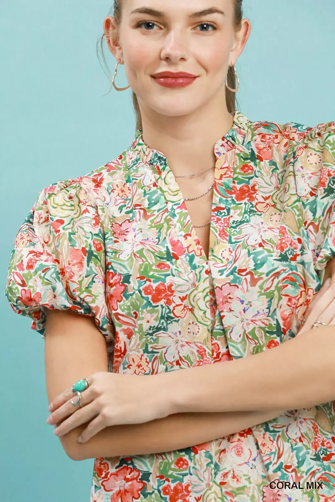 Floral puff-sleeve blouse in coral mix with V-neck and button placket detail