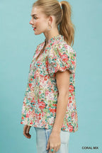 Floral puff-sleeve blouse in coral mix with V-neck and button front, side view