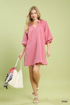 Rose pink textured mini dress with V-neck, balloon sleeves, and scalloped hem