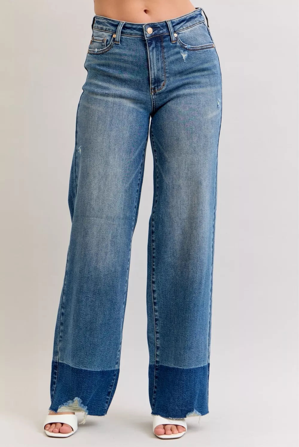 High-waist straight jeans in medium blue denim, raw hem and button fly
