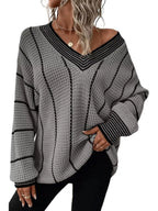 Gray textured knit V-neck sweater with black contrast stripes and ribbed cuffs.