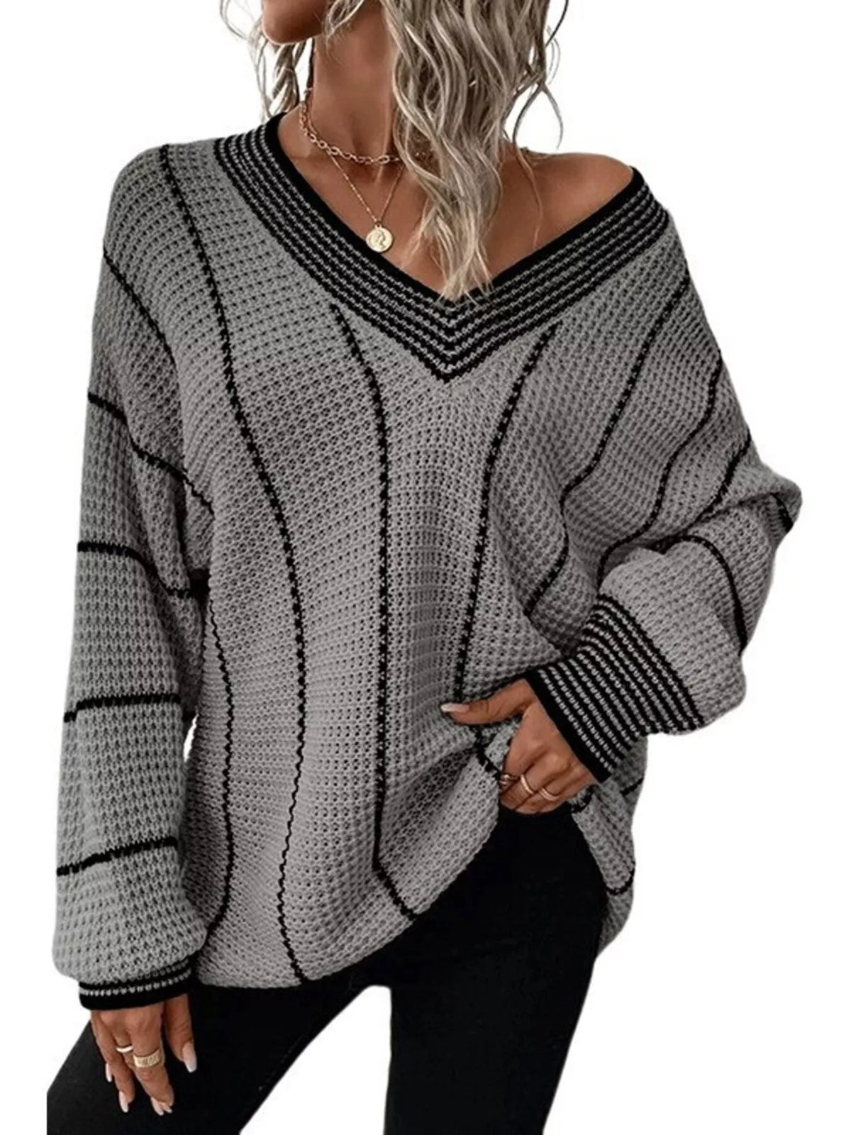 Gray textured knit V-neck sweater with black contrast stripes and ribbed cuffs.