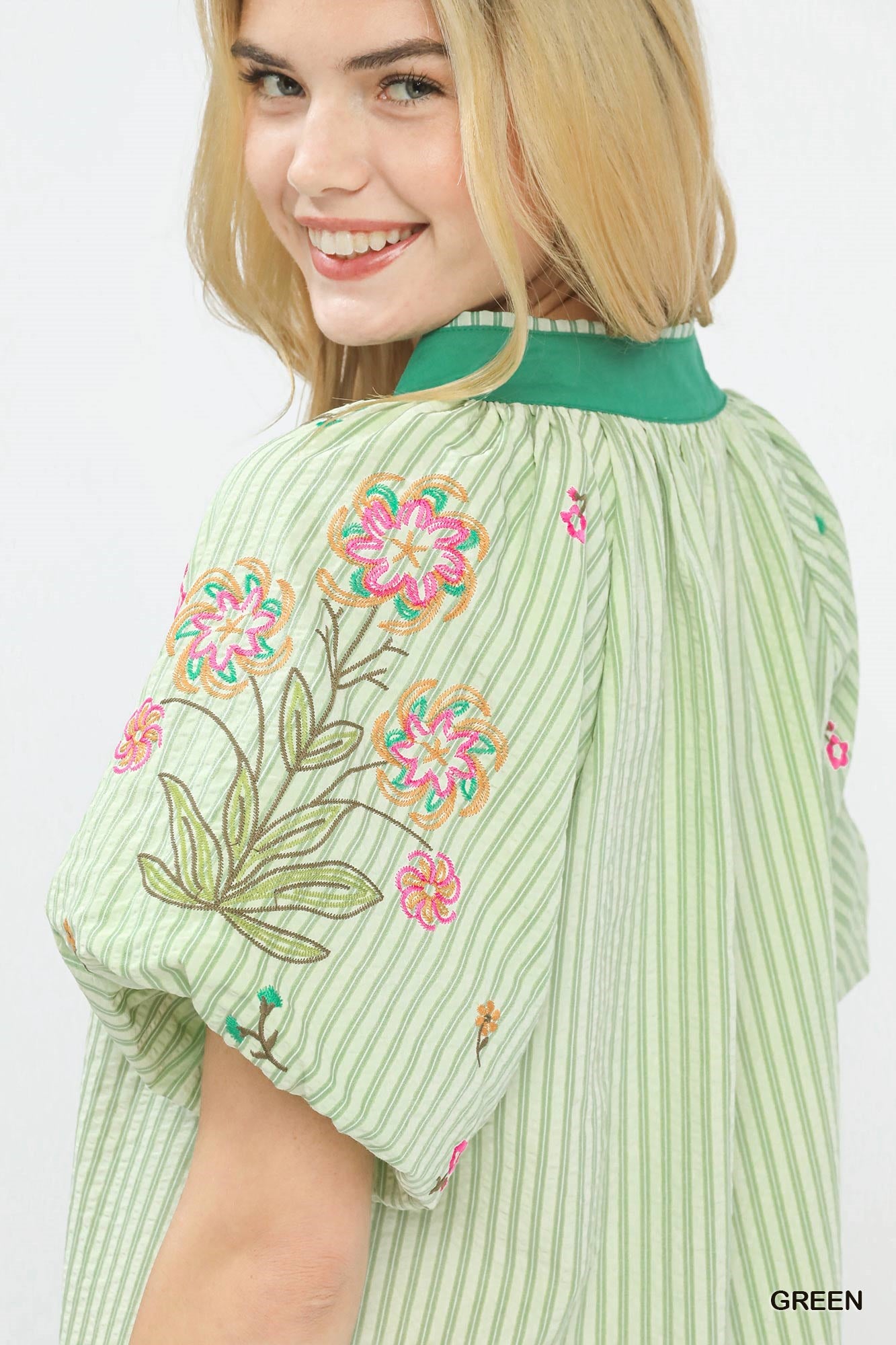 Green striped dolman top with large floral embroidery on puff sleeve