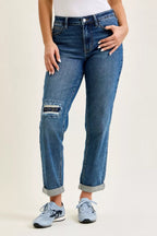 Women’s mid-rise boyfriend jeans with distressed knee and embroidered repair patch