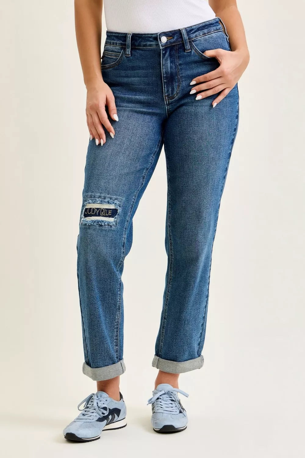 Women’s mid-rise boyfriend jeans with distressed knee and embroidered repair patch