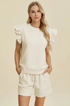 Cream textured two-piece set with ruffle cap sleeves and matching drawstring shorts, front