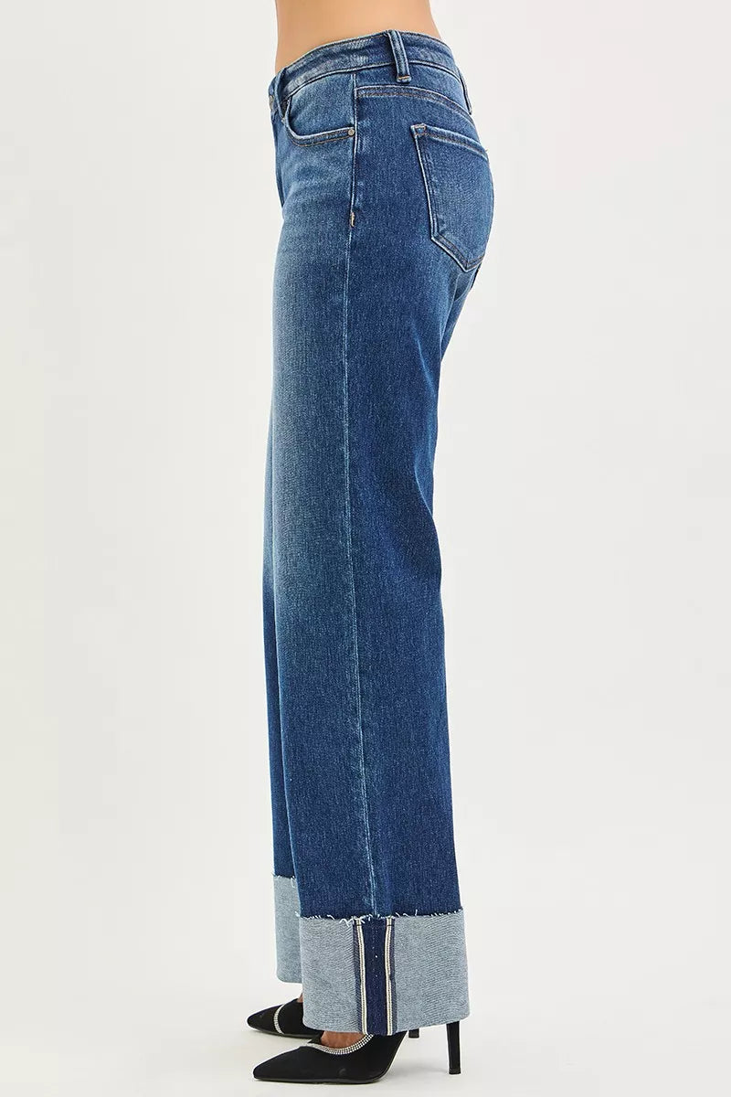 Women’s mid-rise wide-leg jeans in dark blue denim, side view with wide cuff