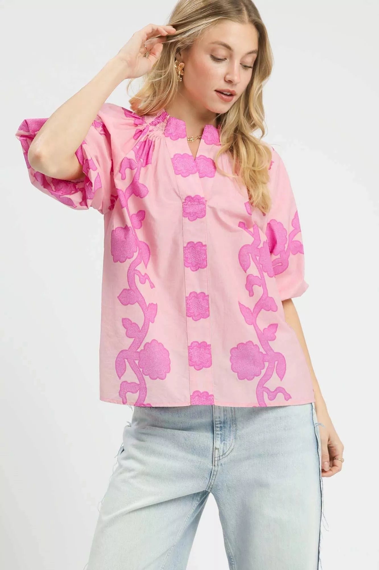 Pink floral blouse with smocked yoke, notched collar, and short puff sleeves