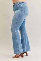 Light blue mid-rise bootcut jeans, back view, with patch pockets and stitched seams