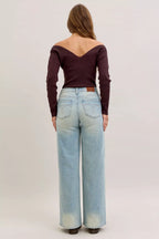 Light blue high-waist straight jeans back view with patch pockets and waistband button