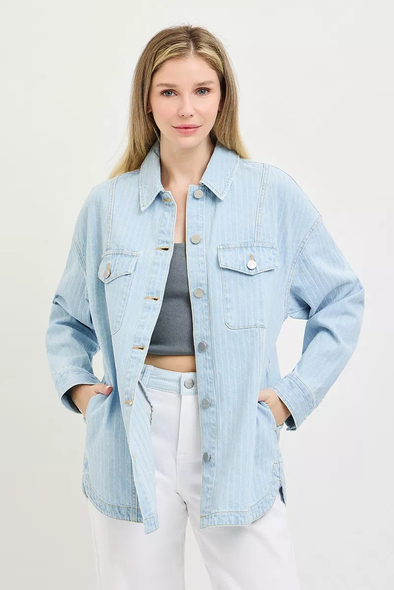 Light blue denim shacket with button front, flap chest pockets, and long sleeves