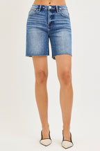 Medium-wash high-rise denim shorts with raw hem, belt loops, button fly.