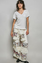 Off-white textured knit V-neck top with lace trim and short sleeves