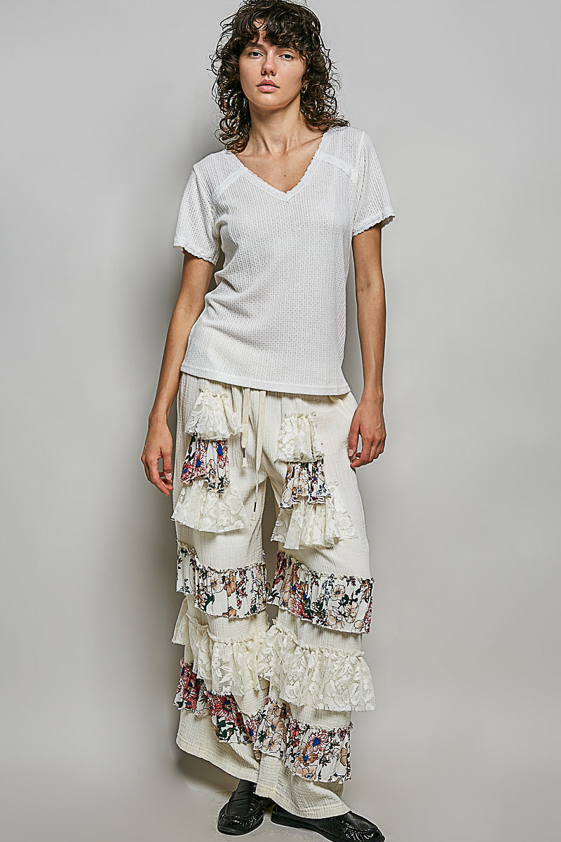 Off-white textured knit V-neck top with lace trim and short sleeves