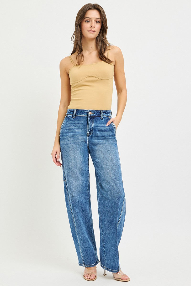 Medium-wash baggy jeans worn with a sleeveless top, relaxed straight-leg fit