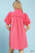 Pink textured eyelet babydoll mini dress with puff sleeves and back yoke