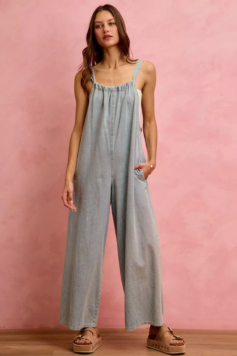 Light blue denim wide-leg overalls with gathered neckline and adjustable straps