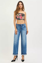 Medium-wash elastic waist cuffed ankle jeans on model, front view