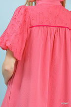 Pink textured eyelet babydoll mini dress with puff sleeves and gathered yoke